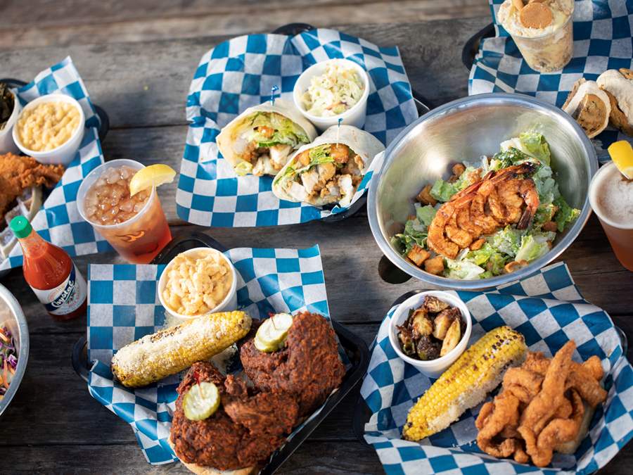 a dinner table with multiple baskets of food